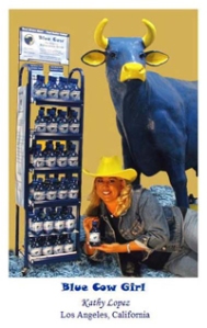 Display case for Blue Cow relaxation drink, cowgirl holding a drink, and a large blue cow standing behind girl.